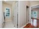 Bright laundry room featuring tile floors, a window, and closet at 3021 Glenwood Dr, Durham, NC 27705