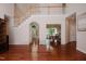 Open-concept living area with hardwood floors leading to the dining room and foyer at 3021 Glenwood Dr, Durham, NC 27705