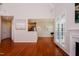 Open living room featuring hardwood floors and fireplace leading into the dining area at 3021 Glenwood Dr, Durham, NC 27705