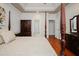 Spacious main bedroom features a tray ceiling, hardwood floors, and a four-poster bed at 3021 Glenwood Dr, Durham, NC 27705