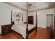 Bedroom with hardwood floors, four-poster bed, and matching furniture at 3021 Glenwood Dr, Durham, NC 27705