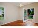 Cozy room features hardwood floors, ceiling fan, and french doors to an outdoor patio at 3021 Glenwood Dr, Durham, NC 27705