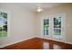 Bright room features hardwood floors, ceiling fan, and french doors to an outdoor patio at 3021 Glenwood Dr, Durham, NC 27705