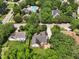 Aerial view of a residential neighborhood with a community pool and surrounding trees at 304 Cayman Ave, Holly Springs, NC 27540