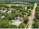 Aerial view of community featuring the pool, clubhouse, school, and road at 304 Cayman Ave, Holly Springs, NC 27540