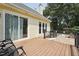 Exterior view of back deck with a sunroom and stairs to the patio at 304 Cayman Ave, Holly Springs, NC 27540