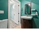 Bathroom featuring a vanity sink, decorative mirror, and neutral walls at 304 Cayman Ave, Holly Springs, NC 27540