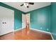 Cozy bedroom with ceiling fan, hardwood floors and natural light at 304 Cayman Ave, Holly Springs, NC 27540