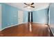 Bright bedroom with hardwood floors, ceiling fan, and a window with natural light at 304 Cayman Ave, Holly Springs, NC 27540