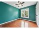 Inviting bedroom featuring a window, ceiling fan, and hardwood floors at 304 Cayman Ave, Holly Springs, NC 27540