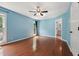 Spacious bedroom with hardwood floors, ceiling fan, and bright natural light at 304 Cayman Ave, Holly Springs, NC 27540