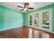 Bright bedroom with large window, offering plenty of natural light and hardwood floors at 304 Cayman Ave, Holly Springs, NC 27540