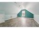 Bright bedroom showcasing sloped ceilings, wood-look floors, and a view to the outdoors at 304 Cayman Ave, Holly Springs, NC 27540