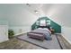 Comfortable bedroom featuring sloped ceilings, a full bed, and a sitting bench at 304 Cayman Ave, Holly Springs, NC 27540
