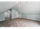 Open bedroom showcasing sloped ceilings, wood-look floors, and neutral tones at 304 Cayman Ave, Holly Springs, NC 27540