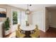 Dining room with pendant lighting and sliding glass door to the deck at 304 Cayman Ave, Holly Springs, NC 27540