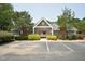 Exterior view of the residential community clubhouse with ample parking at 304 Cayman Ave, Holly Springs, NC 27540