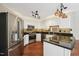 Well-lit kitchen with stainless appliances, granite countertops, and white cabinets at 304 Cayman Ave, Holly Springs, NC 27540