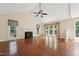 Sun-drenched living room featuring hardwood floors, fireplace, and vaulted ceilings at 304 Cayman Ave, Holly Springs, NC 27540