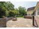 An outdoor patio with stone pavers, a built-in seating area, and a cozy fire pit at 304 Cayman Ave, Holly Springs, NC 27540