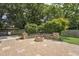 Backyard patio featuring a fire pit and a lush yard at 304 Cayman Ave, Holly Springs, NC 27540