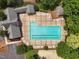 Overhead aerial of a community pool surrounded by lounge chairs and mature trees at 304 Cayman Ave, Holly Springs, NC 27540
