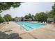 Community swimming pool with lounge chairs and mature trees in the background at 304 Cayman Ave, Holly Springs, NC 27540