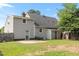 Green backyard with a wooden fence, greenery, and access to the home at 304 Westfield Dr, Dunn, NC 28334