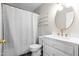 Bright bathroom featuring a shower with a white patterned curtain, a modern vanity, and stylish gold accents at 304 Westfield Dr, Dunn, NC 28334