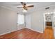 Cozy bedroom with laminate floors, bright windows, and a ceiling fan for added comfort at 304 Westfield Dr, Dunn, NC 28334