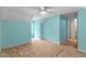Carpeted bedroom featuring a ceiling fan, light blue walls, and natural lighting at 304 Westfield Dr, Dunn, NC 28334