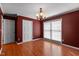Formal dining room with hardwood floors, bright windows, and traditional lighting for memorable meals at 304 Westfield Dr, Dunn, NC 28334