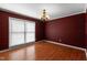 Formal dining room with hardwood floors, large window, and a classic chandelier for elegant dinners at 304 Westfield Dr, Dunn, NC 28334