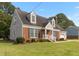 Well-maintained home with a brick facade, dormer windows, green lawn and mature landscaping at 304 Westfield Dr, Dunn, NC 28334
