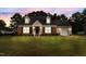 Charming brick home with a well-maintained lawn and inviting curb appeal at twilight at 304 Westfield Dr, Dunn, NC 28334