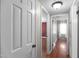 Bright hallway with hardwood floors and neutral walls leading to bedrooms at 304 Westfield Dr, Dunn, NC 28334