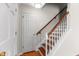 Traditional stairway featuring wood steps, white risers, and a wooden handrail at 304 Westfield Dr, Dunn, NC 28334