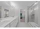Beautiful bathroom showcasing dual vanities, tiled flooring, and a glass walk-in shower at 309 Highland Forest Dr, Fuquay Varina, NC 27526