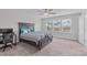 Spacious bedroom with large windows, carpet flooring, and ceiling fan at 309 Highland Forest Dr, Fuquay Varina, NC 27526