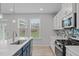 Bright kitchen with modern appliances, white cabinetry, and a functional island at 309 Highland Forest Dr, Fuquay Varina, NC 27526