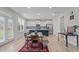 Eat-in kitchen features white cabinets, stainless steel appliances, and a blue island with pendant lighting at 309 Highland Forest Dr, Fuquay Varina, NC 27526