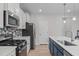 Stylish kitchen features white countertops, modern appliances, and trendy backsplash at 309 Highland Forest Dr, Fuquay Varina, NC 27526