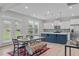 Well-lit kitchen features stainless steel appliances, white cabinets, and a blue center island at 309 Highland Forest Dr, Fuquay Varina, NC 27526