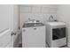Efficient laundry room with modern washer and dryer units and convenient storage shelving at 309 Highland Forest Dr, Fuquay Varina, NC 27526