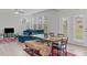 Bright living area featuring a dining area, large windows, and access to the backyard at 309 Highland Forest Dr, Fuquay Varina, NC 27526