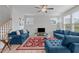 Inviting living room with two plush blue sofas, hardwood floors, and bright natural light at 309 Highland Forest Dr, Fuquay Varina, NC 27526