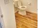 Efficient bathroom showing a toilet and laminate wood flooring at 3207 Geary Trl, Raleigh, NC 27610