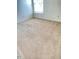 Bright bedroom with beige carpeting, neutral walls, and a window providing natural light at 3207 Geary Trl, Raleigh, NC 27610