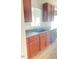 A functional kitchen featuring dark cabinets, a stainless steel faucet and essential appliances at 3207 Geary Trl, Raleigh, NC 27610