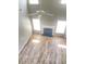 Bright open-concept living area with fireplace, ceiling fan, and attractive laminate flooring at 3207 Geary Trl, Raleigh, NC 27610